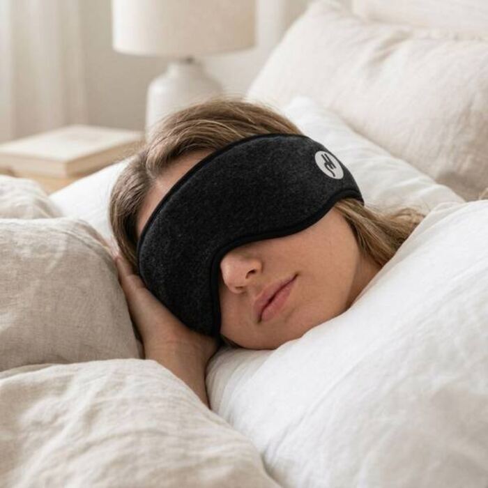 Woman sleeping wearing the black contoured sleep mask